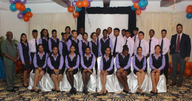 Republic Bank’s newest batch of apprentices flanked by Minister within the Ministry of Social Protection Keith Scott (left) and Managing Director of Republic Bank Guyana Limited Richard Sammy (right)