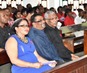 From right in front pew, President David Granger, Regional Chairman,  David Armogan and Regional Executive Officer,  Kim Stephens share a light moment during the Ebenezer Lutheran Church service in New Amsterdam. (Ministry of the Presidency photo)
