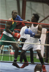Best Boxer awardee, Joel Williamson connects to the chin of Rondell Douglas in the final of the lightweight (elite) bout on Sunday night at the National Gymnasium.