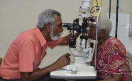 Dr. Deo Singh, Ophthalmologist performs an eye examination on one the patients benefitting from a corneal transplant (GINA photo)