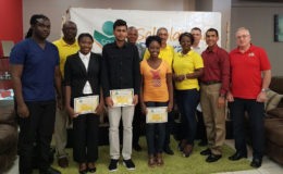 The recipients of the Courts university scholarships, standing with Representatives of Courts Guyana Inc.