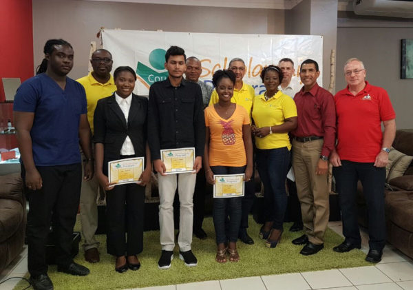 The recipients of the Courts university scholarships, standing with Representatives of Courts Guyana Inc.
