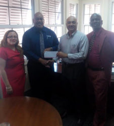 Clarence Perry, Marketing Manager of the Demerara Mutual Group of Companies, hands over sponsorship cheque to Oncar Ramroop, Golf Club President. Left to right: Melissa Dos Santos, Legal Officer and Manager Demerara Mutual Fire & General Insurance, Perry, Ramroop and Guy Griffith, Public Relations Officer, Lusignan Golf Club.