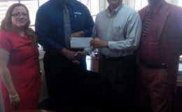 Clarence Perry, Marketing Manager of the Demerara Mutual Group of Companies, hands over sponsorship cheque to Oncar Ramroop, Golf Club President. Left to right: Melissa Dos Santos, Legal Officer and Manager Demerara Mutual Fire & General Insurance, Perry, Ramroop and Guy Griffith, Public Relations Officer, Lusignan Golf Club.