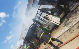 Fire fighters on the scene of yesterday’s fire which completely destroyed three stalls in the Bartica commercial zone