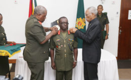 Brigadier George Lewis (centre) being decorated as the new Chief of Staff by President David Granger (right) and outgoing Chief of Staff Brigadier Mark Phillips (left).