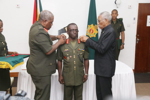 Brigadier George Lewis (centre) being decorated as the new Chief of Staff by President David Granger (right) and outgoing Chief of Staff Brigadier Mark Phillips (left).