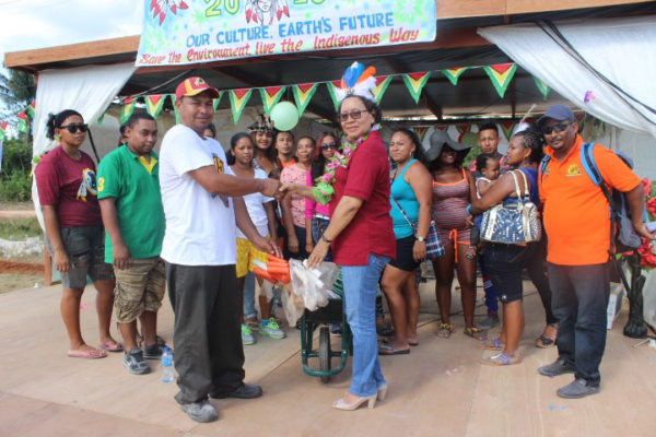 Minister within the Ministry of Indigenous Peoples’ Affairs Valerie Garrido-Lowe (front, right) handing over the agricultural tools to one of the three villages last Thursday. 