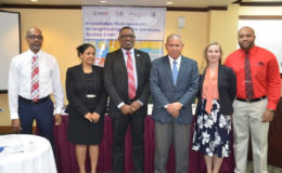  Minister of Public Health Dr George Norton (third, right) is flanked by PANCAP Director Dereck Springer (third, left) and K4Health Project Knowledge Management Advisor Sarah Fohl (second, right). Also in photo are PANCAP Accountant Collin Kirton (left), Knowledge Management Coordinator for the K4Health project Dr Shanti Singh-Anthony (second, left) and K4Health Communications Specialist Timothy Austin (right). 