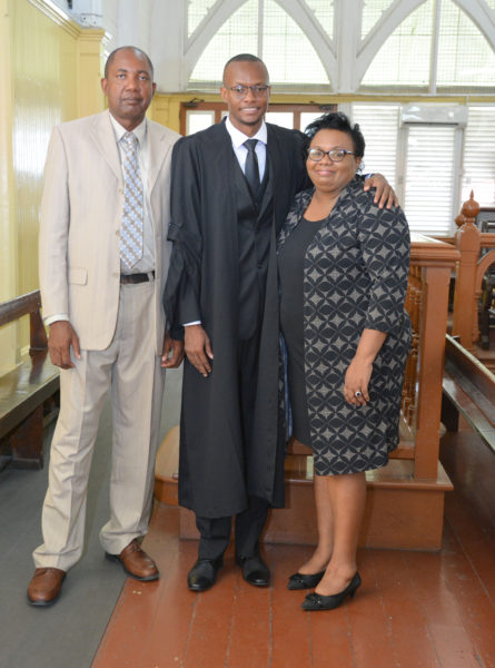 Newly admitted attorney Kiev Chesney flanked by his mother and uncle at the High Court.