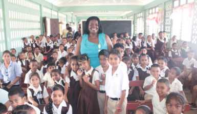 Educator and National Awardee Ingrid Fung (at centre) with students of the Taymouth Manor Primary School, where she yesterday launched a literacy programme.  