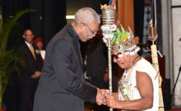 President David Granger congratulates Tony James from the village of Aishalton, after he received a national award for his exemplary service to the Indigenous Peoples of Guyana at the National Cultural Centre yesterday. (Ministry of the Presidency photo) 