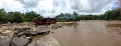 The dredge on the left being manoeuvred away with the cleared channel on the right. 