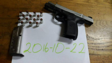 The gun and live ammunition that were found by the police on the trio. (Police photo)