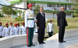 President David Granger (right) paying his respects. (Ministry of the Presidency photo) 