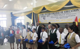 President David Granger (fifth from left back row), Minister of Telecommunications Catherine Hughes (centre) next to Chinese Ambassador Zhang Limin along with some of the students and teachers who received their laptops. 