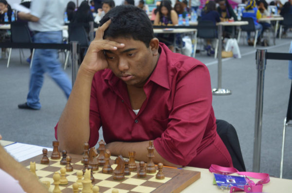 Taffin Khan contesting one of his games for Guyana at the 42nd Chess Olympiad in Baku, Azerbaijan. Khan was the most successful player for the men’s chess team at the Olympiad. He contested ten games, at times playing Board One for his country, and scored victories against Guernsey, Malta, Bermuda and Macau. He drew with Fiji, Guatemala, San Marino and Lesotho and lost to Macedonia and Ghana. Khan’s six points was the highest score from the men’s team.