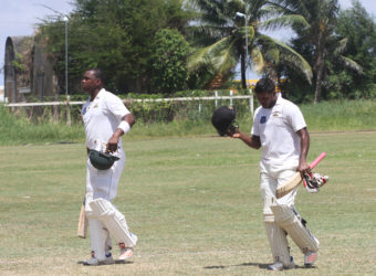 With the armouries in the background, the big ‘guns’ of Christoper Barnwell (143) and Chandrapaul Hemraj (79), head to lunch yesterday on the final day of the GCB’s  practice match at the Everest Cricket Ground. (Photo by Orlando Charles)