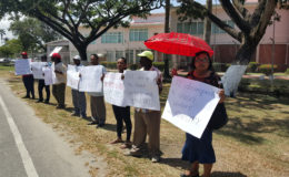 Eleven Demerara Timbers Limited (DTL) workers, who were sacked for protesting in front of the company’s head office last month, yesterday protested outside of the Ministry of the Presidency in hopes of securing President David Granger’s intervention in the case. 