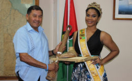 Minister of Indigenous Peoples Affairs Sydney Allicock presenting the Indigenous craft to Miss World Guyana Nuriyyih Gerard.
