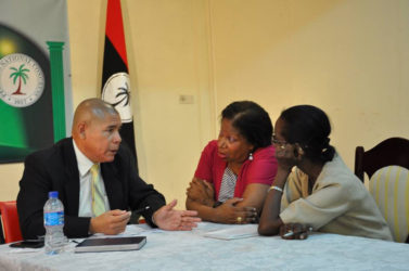 Public Health Minister Dr. George Norton speaking with some members of the public. (PNCR photo) 