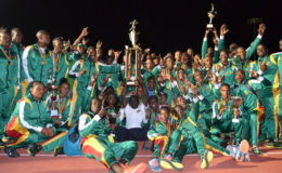 The GDF track and field outfit posing with the  Inter Services Annual Athletic Championship Trophy last night at the National Track and Field Centre. 
