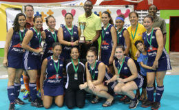 Director of Sports Christopher Jones handing over the Women’s Championship trophy to Bounty GCC captain Tiffany Solomon following the conclusion of the GTT National Indoor Hockey Tournament  (See page 27)
