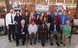 Seated from left: US Ambassador Perry Holloway, Minister of Indigenous Peoples’ Affairs Sydney Allicock, Minister of Foreign Affairs Carl Greenidge, Ministry of the Presidency representative in charge of Environmental Affairs Imole McDonald and Melanie Ingalls, Country Manager for the Peace Corps. Standing behind them are nine of the ten new Peace Corps volunteers. (Photo by Keno George)