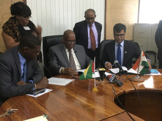 Minister of Finance Winston Jordan (third from left) and Resident Representative from Exim Bank Sailesh Prashad (right) signing the agreement with Minister of Public Infrastructure, David Patterson (left) and High Commissioner of India to Guyana Venkatachalam Mahalingam (second from right) looking on in the Ministry of Finance Boardroom.  