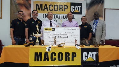 Chief Executive Officer of MACORP Jorge Medinas (3rd from left) handing over the sponsorship cheque to President of the Lusignan Golf Course Oncar Ramroop (3rd from right) while members of MACORP and PRO Guy Griffith looks on.