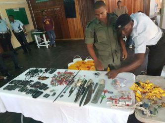 Joint Services members going through the contraband seized yesterday morning at the Georgetown Prison. (Ministry of the Presidency photo) 