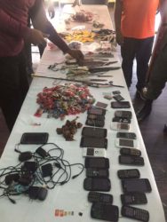 Knives, improvised weapons and cellular phones were among the items Joint Services ranks found during operation Safeguard at the Georgetown Prison yesterday morning. (Ministry of the Presidency photo)