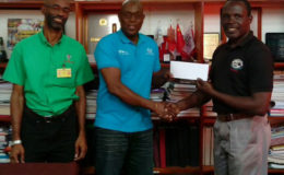  Assistant Secretary/Treasurer of the GOA, Dion Nurse (right) presenting a cheque worth $500,000 to president of the GBA, Steve Ninvalle in the presence of GOA’s Secretary, Garfield Wiltshire.