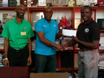  Assistant Secretary/Treasurer of the GOA, Dion Nurse (right) presenting a cheque worth $500,000 to president of the GBA, Steve Ninvalle in the presence of GOA’s Secretary, Garfield Wiltshire.