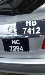 The fake licence plate after it was removed from the one it was pasted over.