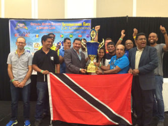 The elated Trinbago Soca Racers pose for a photo with the coveted CMRC country award last night at the Marriott Hotel. Page 25
