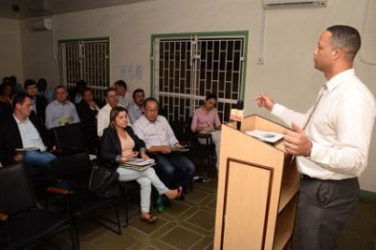 Chief Executive Officer of the Guyana Office for Investment, Owen Verwey (at rostrum), speaking to potential investors  