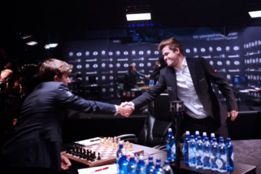 Sergey Karjakin, the challenger (left) shakes the hand of Magnus Carlsen, the defending world champion, before the start of yesterday’s fifth game of their World Chess Championship title match, in Manhattan, New York. (Photo courtesy of FIDE.com) (See page 29)