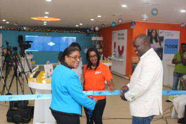 Minister of Public Telecommunications, Cathy Hughes (left) and CEO of GTT Justin Nedd (right) during the ceremonial cutting of the ribbon to launch the new GTT Customer Experience store on Brickdam. 