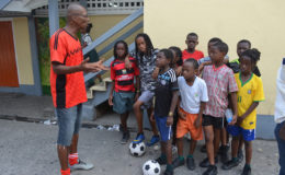 Getting the point across-Head Coach Oscar Payne (left) discussing the final aspects of his tactical plan with the St. Angela’s squad during a training session at the school’s compound ahead of their clash with neighbours St. Agnes. (Orlando Charles photos)