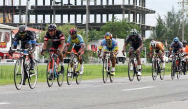 The peloton going full throttle in yesterday’s feature 20-lap race of the Team Alanis cycling programme. (Orlando Charles photo) 