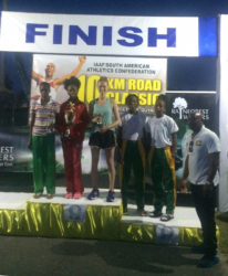 The top male and female prize winners of  the finale of the South American 10k pose for photos yesterday following the race. 