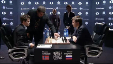 Astrophysicist Neil de Grasse Tyson makes the first move in game eight of the FIDE World Chess Championship between Magnus Carlsen and Serjey Karjakin (Photo courtesy of FIDE.com) 