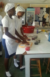 Students preparing the fruits for their fruit cake.