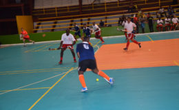 GCC’S Kevin Spencer (no.6) initiating an offensive foray while being pursued by Aderemi Simon (left) of Old Fort during the opening match of the Diamond Mineral Water International Indoor Hockey Festival at the National Gymnasium