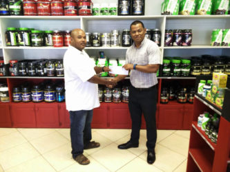 Fitness Express’ Ian Rogers handing over the sponsorship to GAPF’s Andrew Austin recently.  			 	 	