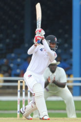 Debutant left-hander Isaiah Rajah drives elegantly through the off-side during his half-century on Saturday. (Photo courtesy WICB Media) 