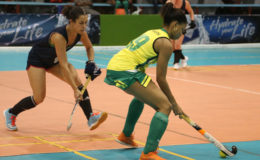 Leigh Sandison (left) of Toronto Toros in the process of challenging Krezia Layne of Woodpecker Hikers for possession of the ball during her team’s 4-3 win at the National Gymnasium