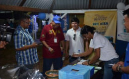 Minister of Indigenous Peoples Affairs Sydney Allicock (second from left) taking a look at a local product at the 16th Rupununi Expo (GINA photo)