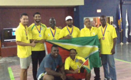 Guyana’s weight lifting outfit pose for a photo with the Golden Arrowhead at the Barbados Independence Invitational. 
